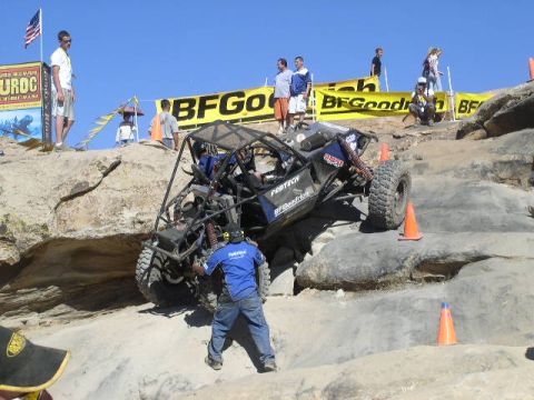 1979 Ford Bronco - A custom-built off-road buggy navigates a challenging rocky course with spectators watching.