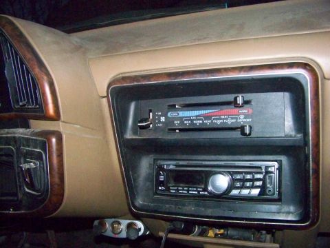 1989 Ford Bronco - Interior of a 1989 Ford Bronco, climate controls, an aftermarket stereo, and dual cigarette lighter ports.