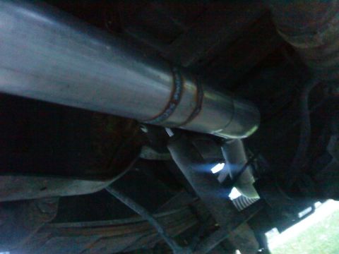 1995 Ford Bronco - A close-up view shows a freshly welded section of a vehicle's exhaust system.