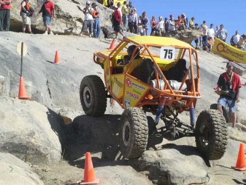 1979 Ford Bronco - A custom-built off-road buggy navigates a challenging rocky terrain during an event.