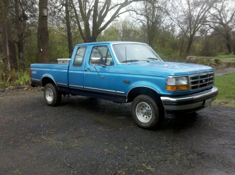 1992 Ford F-150 - Blue 1992 Ford F-150 extended cab pickup truck with a toolbox in the bed.