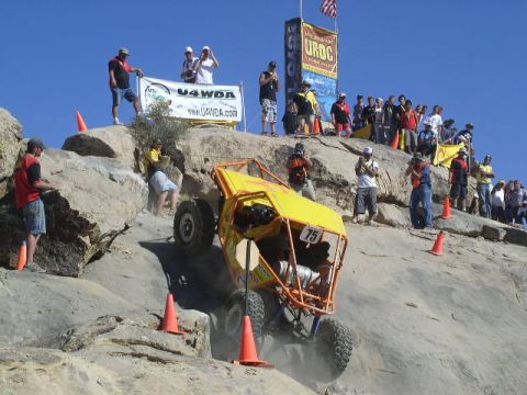 1979 Ford Bronco - A custom-built buggy navigates a challenging rocky terrain during an off-road event.