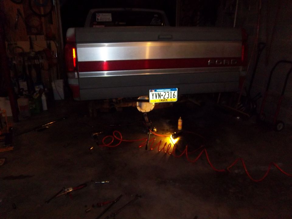 Gray and red Ford F-150 tailgate with a Pennsylvania license plate YVN-2316, viewed from the rear