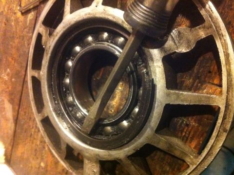 1989 Ford Bronco - A wheel bearing is being serviced with a chisel.
