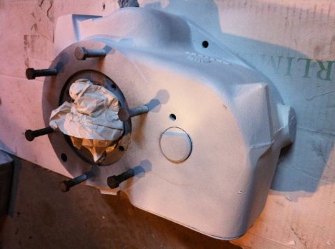 1989 Ford Bronco - A close-up view of a gray transfer case housing, showing bolted connections and internal paper packing.