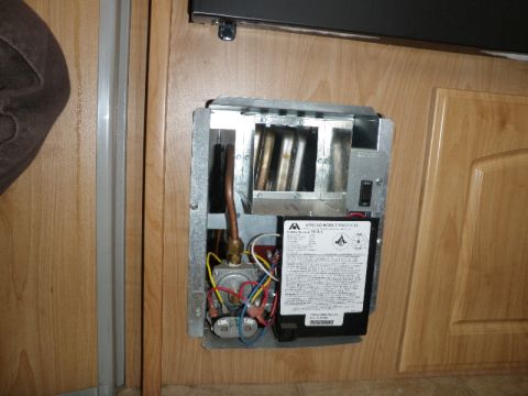 2007 Dodge 2500 - Close-up of an interior water heater unit with visible components and a manufacturer's label.