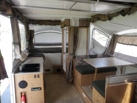 2007 Dodge 2500 - Pop-up camper interior with kitchen, dinette, and fold-out beds visible.