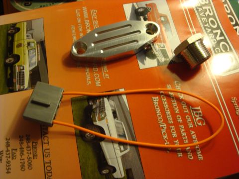 1989 Ford Bronco - Automotive parts are laid out on a catalog images of Ford trucks.