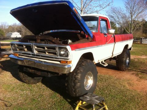 1986 Ford F-150 - This pickup truck, likely from the early to mid-1970s, has its hood open, revealing the engine bay.