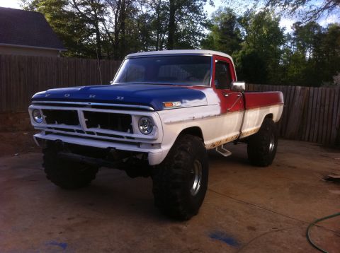 1986 Ford F-150 - This lifted Ford pickup truck has a red, white, and blue paint scheme.