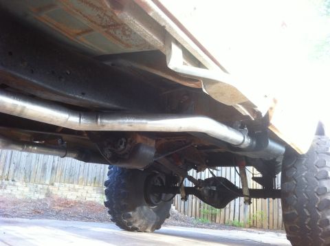 1986 Ford F-150 - The photo shows the undercarriage of a pickup truck, focusing on the rear axle and exhaust system.