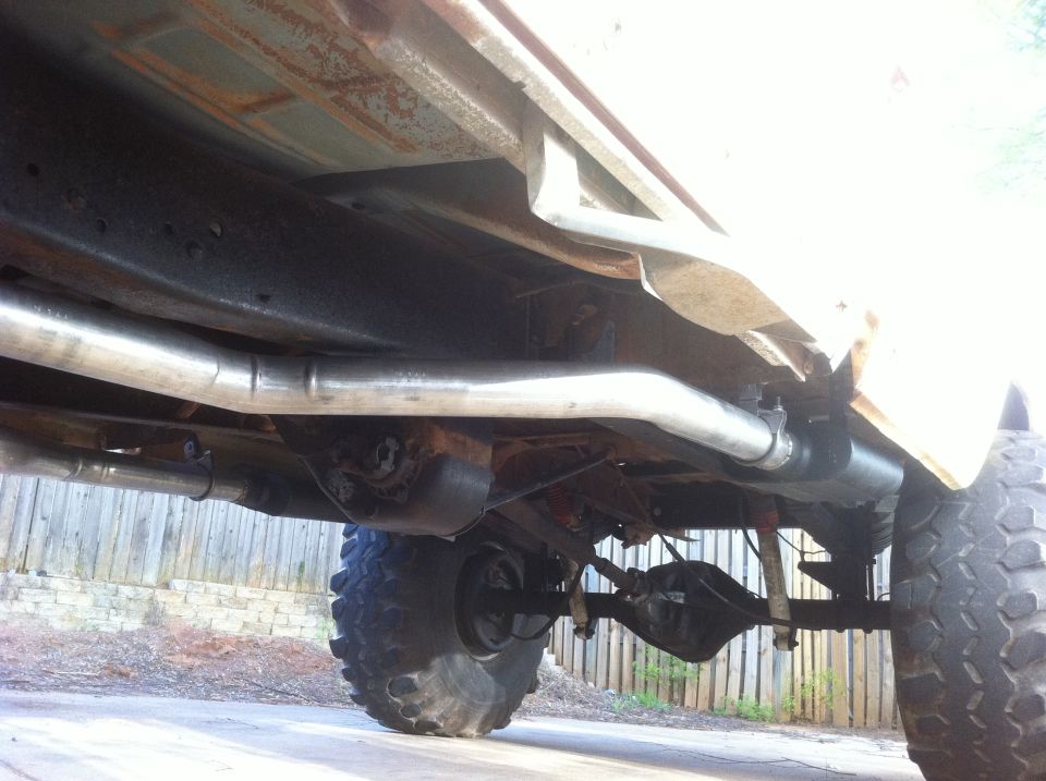 Underside view of a pickup truck's rear axle and exhaust system