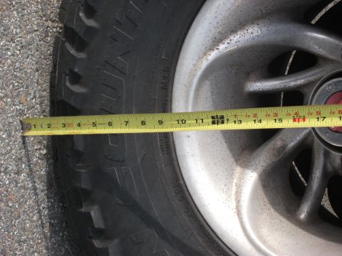 1996 Ford Bronco - A measuring tape is placed across a tire and wheel assembly, showing a portion of the tread and rim.