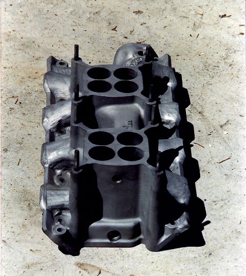 1973 Ford Mustang - This is an aluminum intake manifold, likely for a V8 engine, shown on a concrete surface.