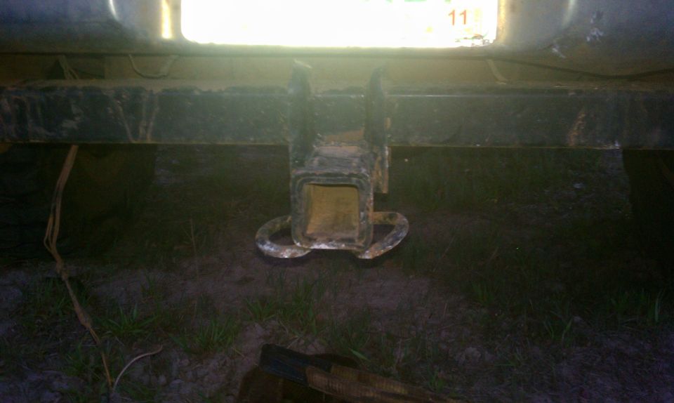 Rear view of a trailer hitch with a license plate above it. The license plate has the number 11 visible