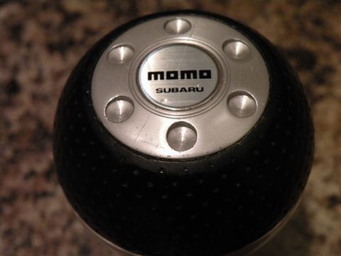 2006 Subaru Legacy - A close-up view of a Momo Subaru shift knob, indicating it is a vehicle part.