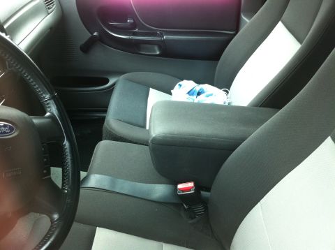 1993 Ford Taurus - The interior of a Ford Ranger pickup truck is shown, the driver's seat and center console.