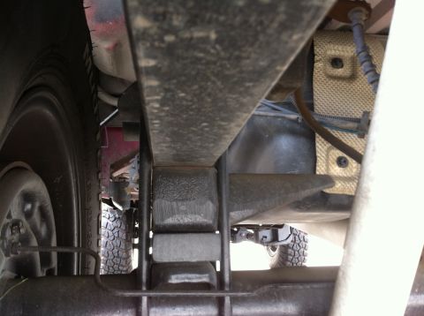 1993 Ford Taurus - Undercarriage view of a vehicle's suspension system, focusing on the leaf springs and bump stops.