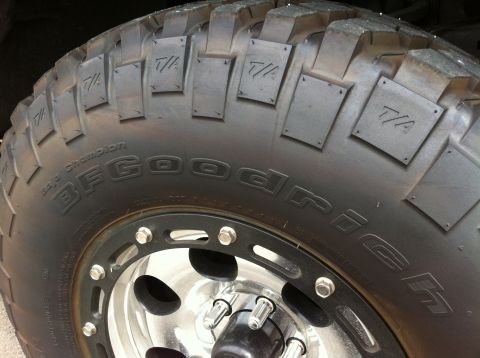 1993 Ford Taurus - Close-up of a BFGoodrich Baja Champion tire, showing the T/A markings on the tread blocks and the brand name on the sidewall.