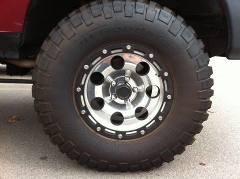 1993 Ford Taurus - Close-up of a off-road tire and custom rim mounted on a vehicle.