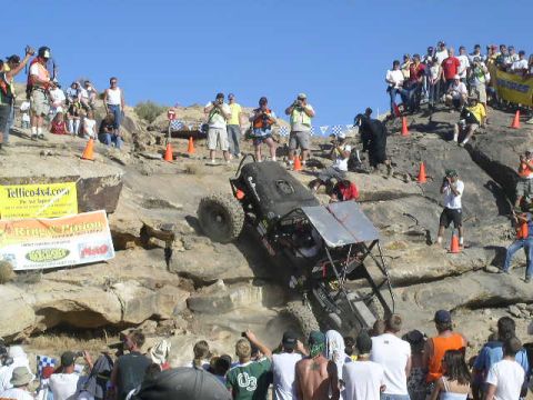 1979 Ford Bronco - Spectators gather to watch an extreme off-road vehicle navigate a challenging rocky terrain.