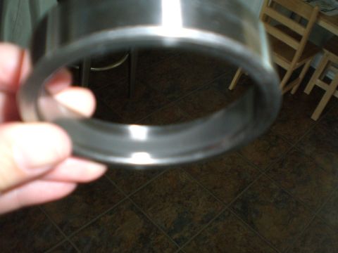 1999 Chevrolet Camaro - Close-up of a metal bearing part being held, with chairs visible in the background.
