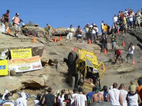1979 Ford Bronco - An off-road buggy attempts to climb a challenging rocky terrain during a competition.
