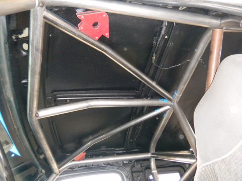 1997 Ford Ranger - Custom roll cage installed inside a vehicle, with a magnetic clamp on the roof panel.