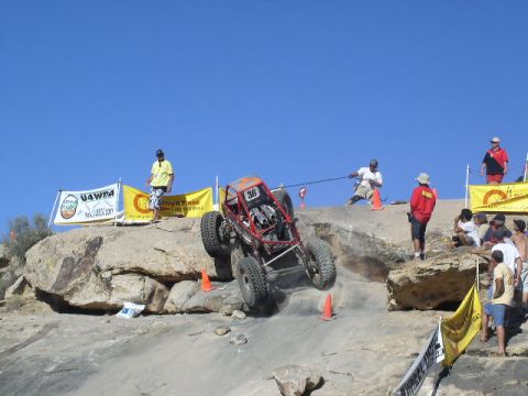 1979 Ford Bronco - An off-road buggy navigates a challenging rocky terrain during a competition.