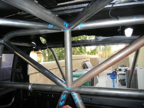 1997 Ford Ranger - A custom roll cage is installed inside a vehicle, with visible markings and labels indicating installation points.
