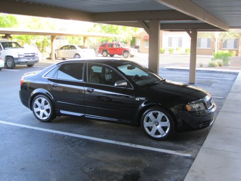 2005 Audi S4 - A black 2005 Audi S4 sedan is parked in a carport, with other vehicles visible in the background.