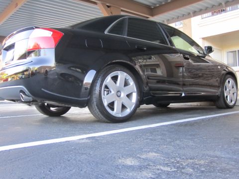 2005 Audi S4 - A black sedan is parked in a lot, viewed from the rear three-quarter angle, highlighting its taillights and alloy wheels.