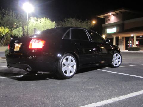 2005 Audi S4 - Rear view of a black 2005 Audi S4 sedan parked at night in a commercial parking lot.