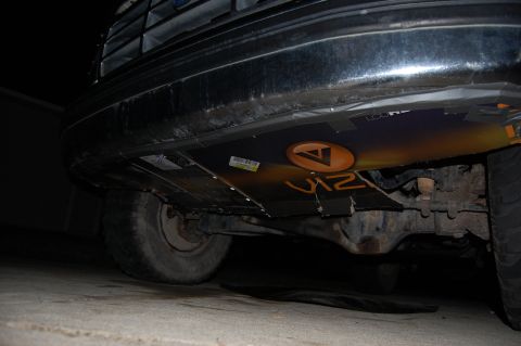 1994 Ford Bronco - Custom panels are attached to the undercarriage of the vehicle, a logo and text.
