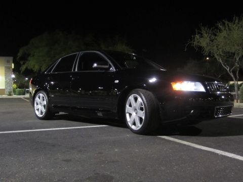 2005 Audi S4 - This black 2005 Audi S4 sedan is captured in a three-quarter front view under nighttime lighting.