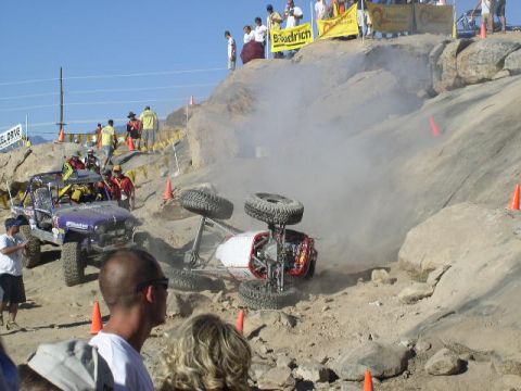 1979 Ford Bronco - Two off-road vehicles are competing on a challenging rocky course, with one vehicle overturned.