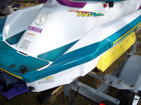 1996 Yamaha RA760 WaveRaider 2-P - Close-up view of a white jet ski with teal and yellow accents, the '760' model designation.