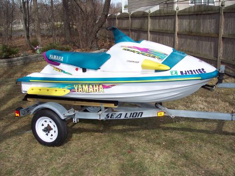 1996 Yamaha RA760 WaveRaider 2-P - This 1996 Yamaha WaveRaider jet ski features a white body with teal and purple graphics and seating.