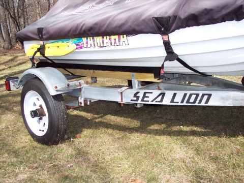 1996 Yamaha RA760 WaveRaider 2-P - A personal watercraft, branded Yamaha, is parked on a Sea Lion trailer.