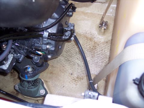 1996 Yamaha RA760 WaveRaider 2-P - Close-up view of the engine and plumbing inside a jet ski's compartment.