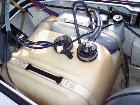 1996 Yamaha RA760 WaveRaider 2-P - Close-up view of the fuel tanks and plumbing within a jet ski's engine compartment.
