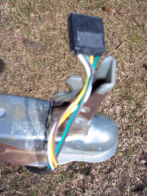 1996 Yamaha RA760 WaveRaider 2-P - Close-up of a trailer hitch wiring harness, showing the black connector and the white, yellow, green, and purple wires.