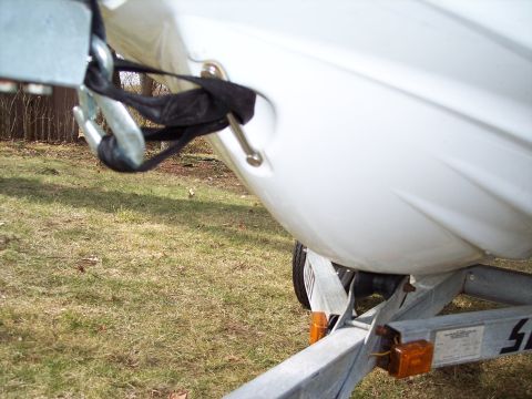 1996 Yamaha RA760 WaveRaider 2-P - A personal watercraft is tied down to a trailer with a metal hook and black strap.