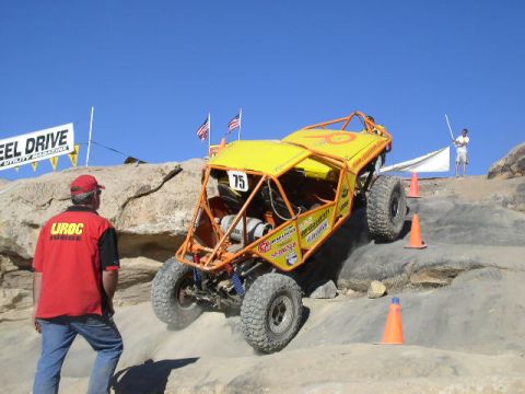 1979 Ford Bronco - A custom-built off-road buggy navigates a rocky incline during an event.