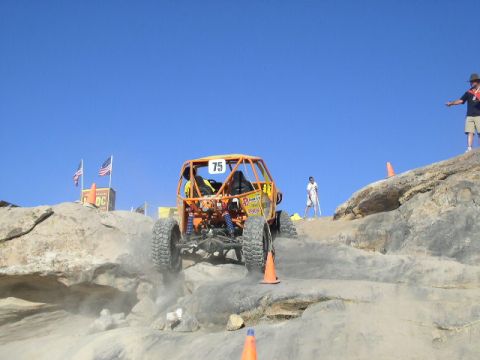 1979 Ford Bronco - An off-road buggy navigates a challenging rocky terrain during an event.