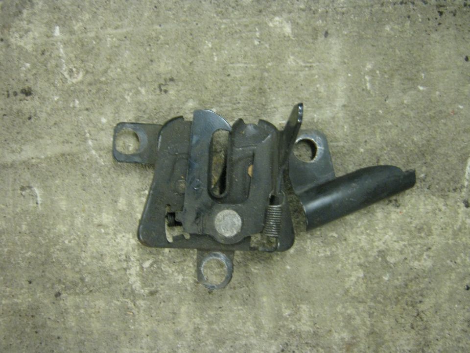 Hood latch assembly on a concrete floor