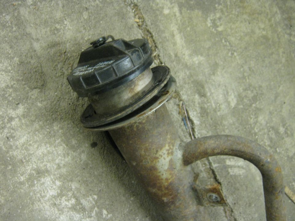 Fuel filler neck with cap on a concrete floor