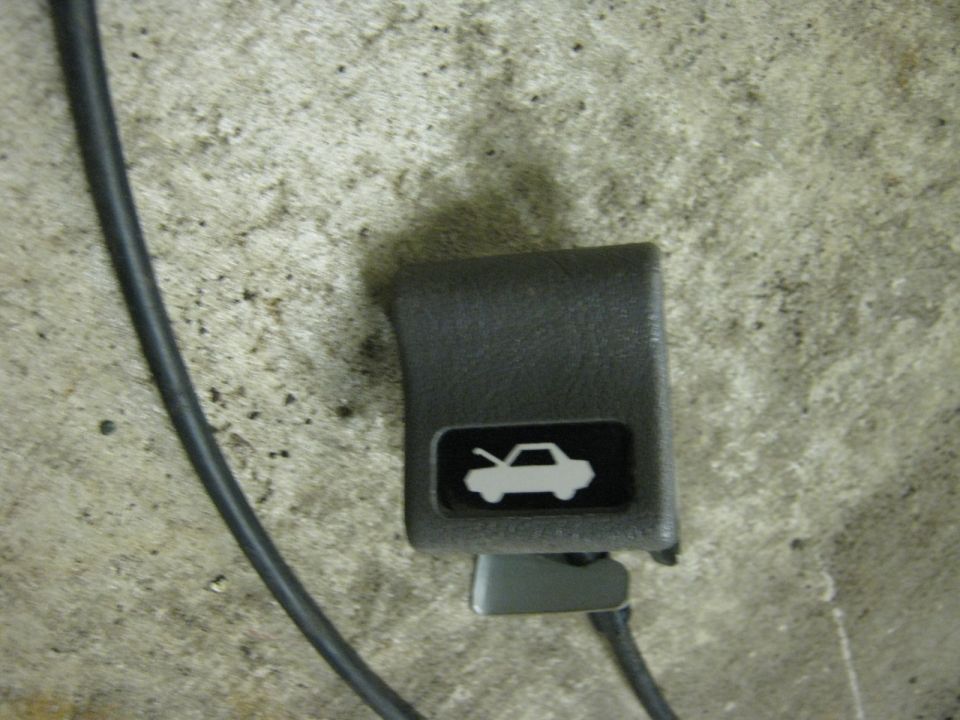 Gray hood release handle with hood icon