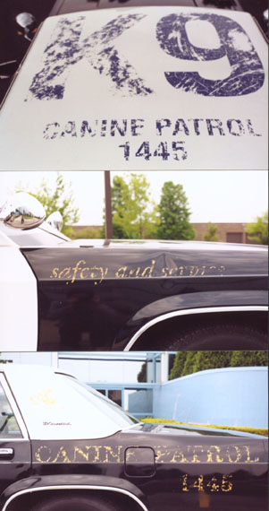 1991 Ford LTD Crown Victoria - Police car marked for K9 unit, displaying 'Canine Patrol 1445' and 'safety and service'.