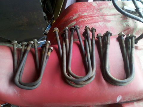 2003 Ford F-250 - A collection of U-bolts, likely for vehicle suspension, are visible in this close-up shot.